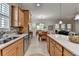 Sunlit kitchen with wooden cabinets, a center island, stainless steel appliances and a view into dining area at 4230 Braden Nw Ln, Kennesaw, GA 30144