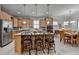 Bright kitchen boasts stainless steel appliances, wooden cabinets, and a large island with bar seating at 4230 Braden Nw Ln, Kennesaw, GA 30144