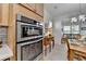 Bright kitchen features stainless steel double oven and seamless flow into the open-concept dining area at 4230 Braden Nw Ln, Kennesaw, GA 30144