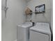 Efficient laundry room with modern washer and dryer, wire racks and storage basket at 4230 Braden Nw Ln, Kennesaw, GA 30144