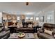 Open concept living area with view of kitchen, dining area, and large leather seating at 4230 Braden Nw Ln, Kennesaw, GA 30144