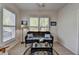 Bright living room with shuttered windows, wicker furniture set, and charming decor, perfect for relaxing at 4230 Braden Nw Ln, Kennesaw, GA 30144