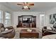 Comfortable living room with a ceiling fan, dark leather seating, and large entertainment center at 4230 Braden Nw Ln, Kennesaw, GA 30144