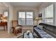 Cozy living room with shuttered windows, wicker sofa, and wooden rocking chair, creating a warm atmosphere at 4230 Braden Nw Ln, Kennesaw, GA 30144