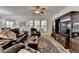 Comfortable living room featuring dark leather seating, large windows, and a dark wood entertainment center at 4230 Braden Nw Ln, Kennesaw, GA 30144