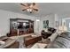Cozy living room boasts comfortable leather seating, a ceiling fan, and stylish decor at 4230 Braden Nw Ln, Kennesaw, GA 30144