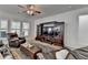 Bright living room with tile flooring, large windows, and a dark wood entertainment center at 4230 Braden Nw Ln, Kennesaw, GA 30144