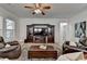 Living room with ceiling fan, entertainment center, and comfortable leather seating at 4230 Braden Nw Ln, Kennesaw, GA 30144