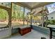 Enclosed patio leading to a landscaped backyard featuring a wooden pergola and exterior seating at 4230 Braden Nw Ln, Kennesaw, GA 30144