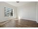 Bright bedroom featuring hardwood floors and a large window offering city views at 1101 Juniper Ne St # 1511, Atlanta, GA 30309
