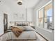 Cozy bedroom with natural light from the window, complemented by two bedside tables with lamps at 1101 Juniper Ne St # 1511, Atlanta, GA 30309