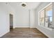 Bright bedroom featuring hardwood floors, a modern ceiling fan, and a large window with balcony access at 1101 Juniper Ne St # 1511, Atlanta, GA 30309