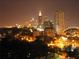 Striking cityscape view at night, featuring illuminated buildings and lush trees at 1101 Juniper Ne St # 1511, Atlanta, GA 30309