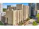 Tan building featuring many balconies and mature trees around the property at 1101 Juniper Ne St # 1511, Atlanta, GA 30309