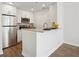 Modern kitchen features white cabinets, stainless steel appliances, and granite countertops with breakfast bar at 1101 Juniper Ne St # 1511, Atlanta, GA 30309