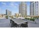 Amazing roof deck with a dining table, chairs, potted plants, lounge furniture and skyscraper views at 1101 Juniper Ne St # 1511, Atlanta, GA 30309