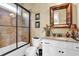 Bathroom with shower and bathtub combination, a granite vanity top, and a decorative mirror at 2450 Weber Heights Way, Buford, GA 30519