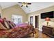 Comfortable bedroom with a vaulted ceiling, TV, and hardwood floors at 2450 Weber Heights Way, Buford, GA 30519