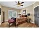 Comfortable bedroom featuring a ceiling fan and natural light from a window with shutters at 2450 Weber Heights Way, Buford, GA 30519