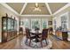 Bright dining area with large windows, wood floors, and an elegant ceiling fan at 2450 Weber Heights Way, Buford, GA 30519