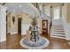 Elegant foyer with a staircase, hardwood floors, and decorative accents at 2450 Weber Heights Way, Buford, GA 30519