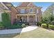 Elegant brick home featuring manicured landscaping and a welcoming stone-accented entrance at 2450 Weber Heights Way, Buford, GA 30519