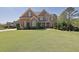 Beautiful brick home with stone accents and lush green lawn at 2450 Weber Heights Way, Buford, GA 30519