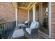 Inviting front porch with comfortable seating and a view of the lush surroundings at 2450 Weber Heights Way, Buford, GA 30519