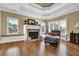 Inviting living room with fireplace, built-in bench seating, and a large window with plantation shutters at 2450 Weber Heights Way, Buford, GA 30519