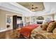 Spacious main bedroom featuring tray ceilings, fireplace, and ensuite bathroom with jacuzzi tub at 2450 Weber Heights Way, Buford, GA 30519
