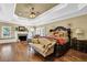 Luxurious main bedroom with tray ceiling, fireplace, and sitting area at 2450 Weber Heights Way, Buford, GA 30519