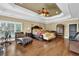 Elegantly designed main bedroom with hardwood floors, ample furniture, and abundant natural light at 2450 Weber Heights Way, Buford, GA 30519