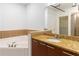 Bathroom featuring a granite-topped vanity, a large soaking tub and a walk-in shower at 264 19Th Nw St # 2308, Atlanta, GA 30363