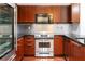 Modern kitchen with stainless steel appliances and dark granite countertops at 264 19Th Nw St # 2308, Atlanta, GA 30363