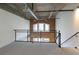 Loft area with neutral carpet and railings overlooking the living room with exposed brick and large windows at 264 19Th Nw St # 2308, Atlanta, GA 30363