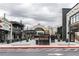 Outdoor plaza surrounded by shops and restaurants with string lights overhead at 264 19Th Nw St # 2308, Atlanta, GA 30363