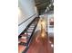 Modern staircase with wooden steps and metal railings leads to an upper level in this stylish home at 264 19Th Nw St # 2308, Atlanta, GA 30363