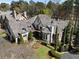 Aerial view showcasing a beautiful multi-story home, well-manicured landscaping, and mature trees at 290 Ardsley Ln, Alpharetta, GA 30005