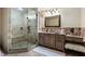 Bathroom with neutral finishes, vanity and framed mirror, tile shower with glass door, and makeup vanity at 290 Ardsley Ln, Alpharetta, GA 30005