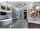 Modern bathroom featuring a soaking tub, walk-in shower, dual vanity, and stylish lighting at 290 Ardsley Ln, Alpharetta, GA 30005