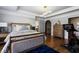 Bedroom with hardwood floors, tray ceiling, ensuite bathroom, and Peloton bike at 290 Ardsley Ln, Alpharetta, GA 30005