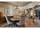 Elegant dining room with stone floors, decorative columns, and a round wooden table at 290 Ardsley Ln, Alpharetta, GA 30005