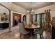 Elegant dining room with stone floors, decorative columns, and a round wooden table at 290 Ardsley Ln, Alpharetta, GA 30005