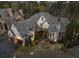 Stunning exterior elevation of stone home with turret, manicured landscaping and mature trees at 290 Ardsley Ln, Alpharetta, GA 30005