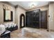 Open foyer with stone flooring, a decorative front door, built-in storage, and bench seating at 290 Ardsley Ln, Alpharetta, GA 30005
