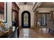 Grand foyer with high ceilings, stone floors, an iron door, and elegant decor at 290 Ardsley Ln, Alpharetta, GA 30005