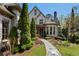 Charming stone home with manicured landscaping and a stone walkway to the front door at 290 Ardsley Ln, Alpharetta, GA 30005