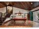 Game room with pool table, staircase, wood plank ceiling, chandelier, and hardwood floors at 290 Ardsley Ln, Alpharetta, GA 30005