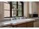 Charming kitchen sink with granite countertops, mosaic backsplash, and a large window, providing a bright and pleasant workspace at 290 Ardsley Ln, Alpharetta, GA 30005