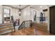 Upstairs landing with hardwood floors and iron railing at 290 Ardsley Ln, Alpharetta, GA 30005